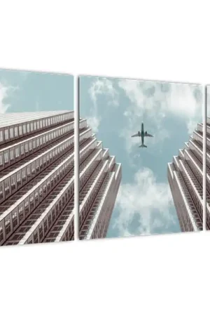 Niska cena Schilderij - Vliegtuig boven gebouwen