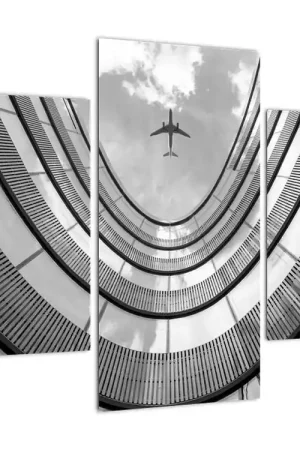 Schilderij - Vliegtuig boven een gebouw Bezpieczna płatność